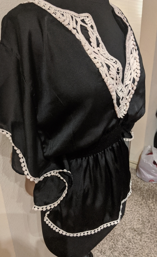 Black cinched waist peplum style blouse